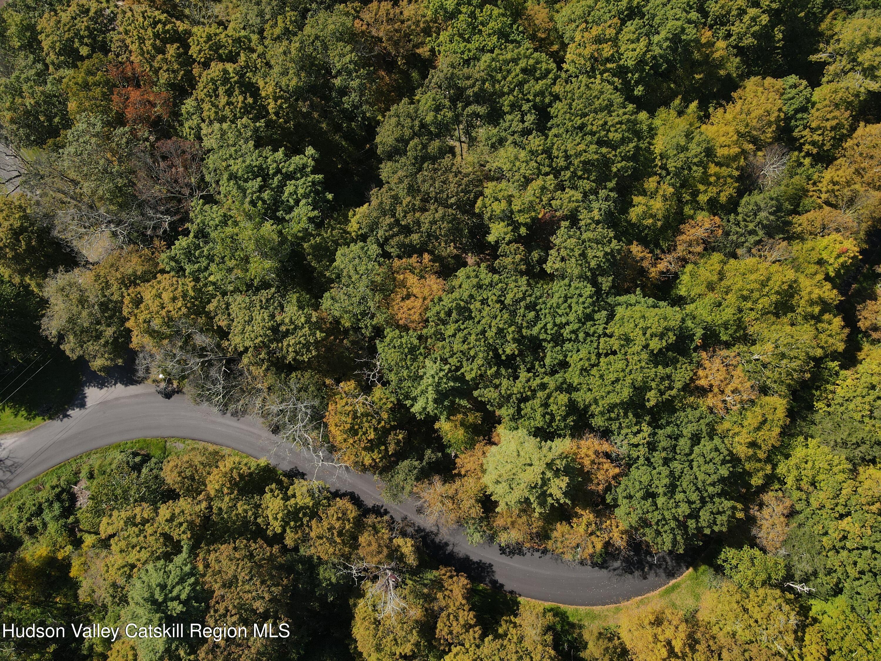 an aerial view of a residential houses with yard
