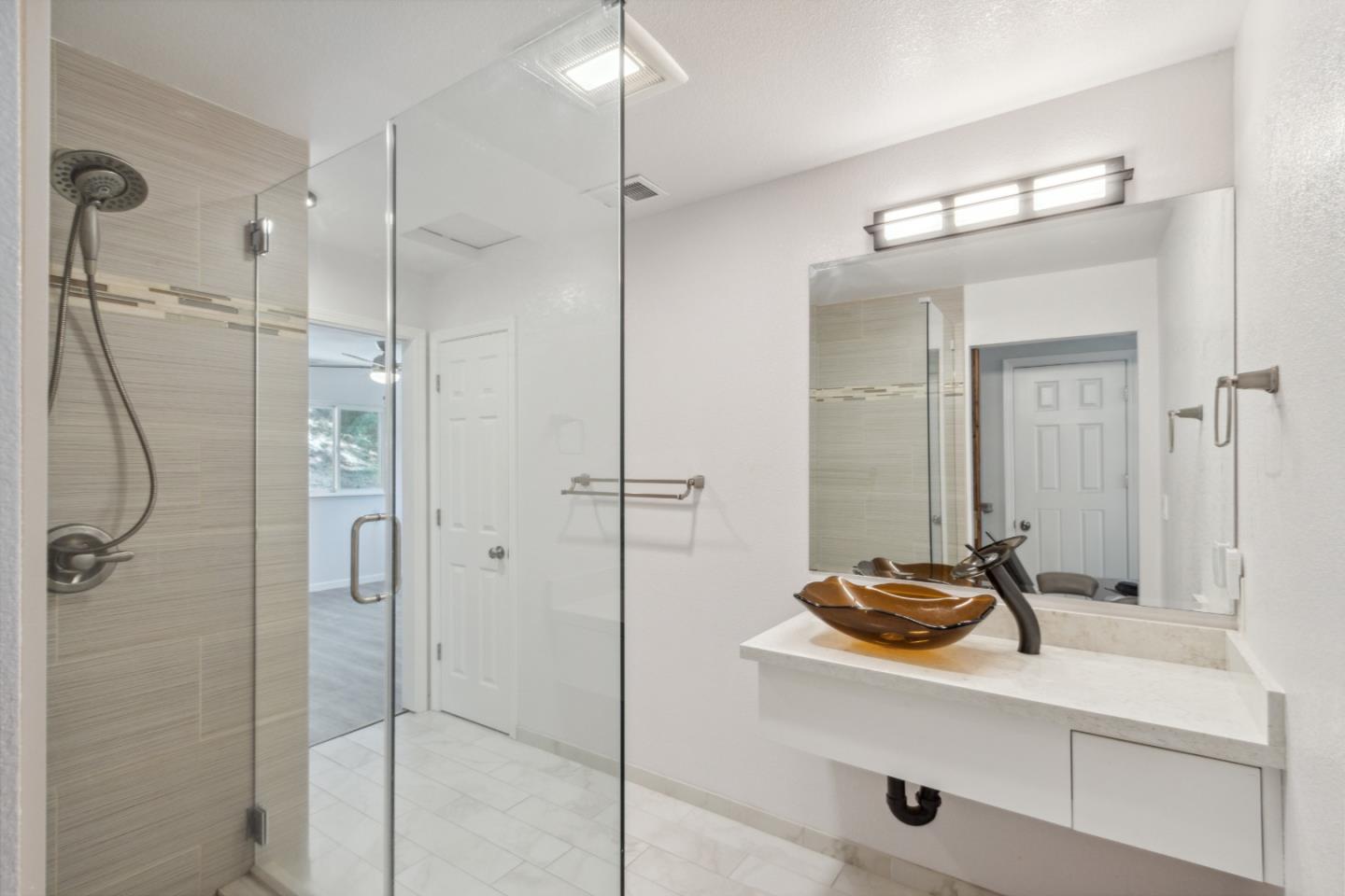 24895 Skyland Road Los Gatos, CA 95033 - Photo 21 of 113 a bathroom with a shower sink and mirror