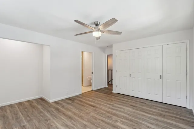 a view of a patio with table and chairs potted plants with wooden floor and fence