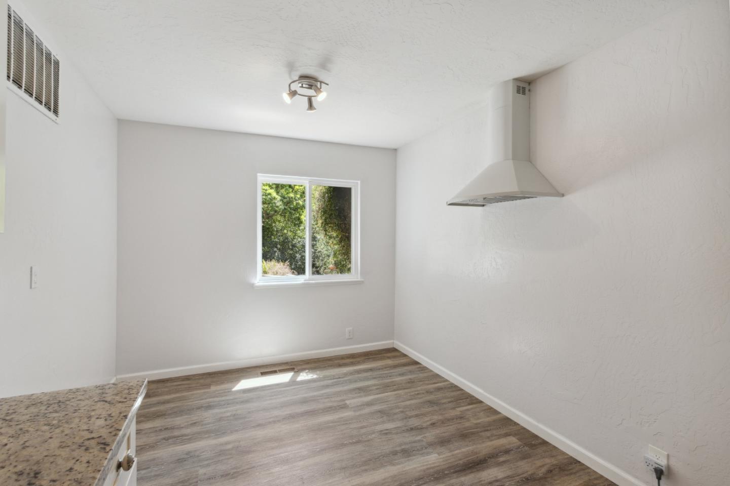 24895 Skyland Road Los Gatos, CA 95033 - Photo 29 of 113 an empty room with wooden floor and window