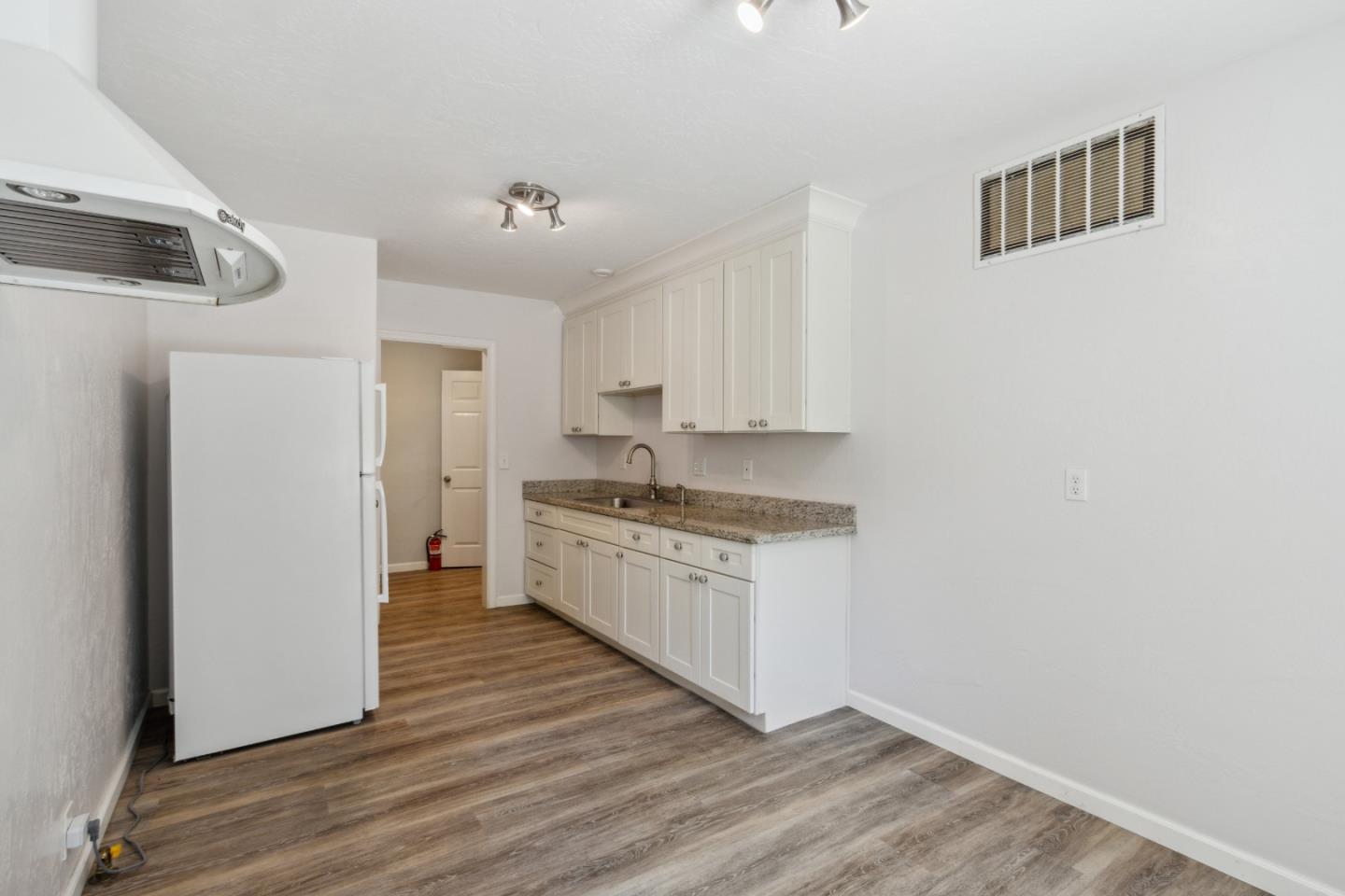 24895 Skyland Road Los Gatos, CA 95033 - Photo 30 of 113 a kitchen with granite countertop white cabinets and white appliances