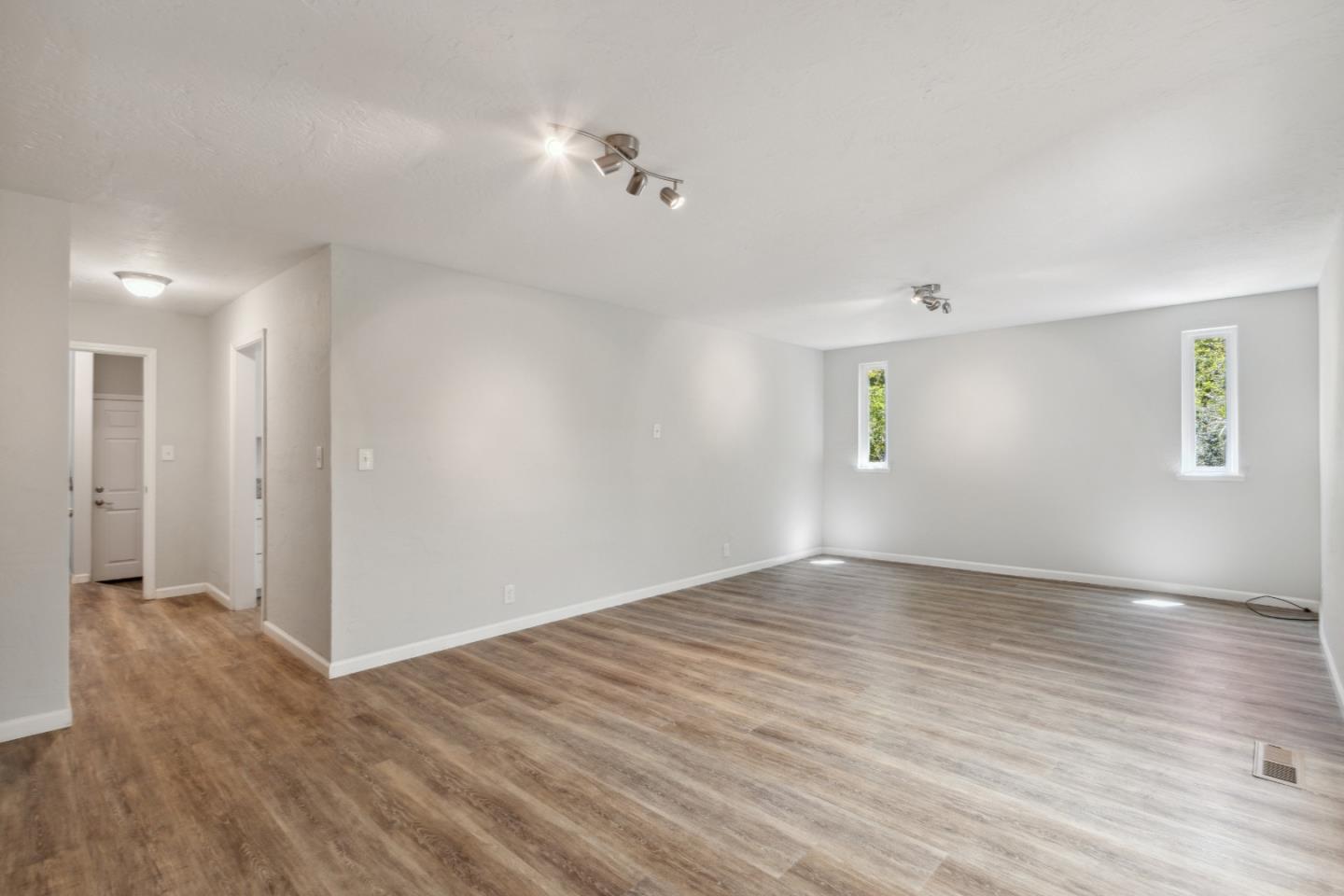 24895 Skyland Road Los Gatos, CA 95033 - Photo 33 of 113 a view of an empty room with wooden floor and a window