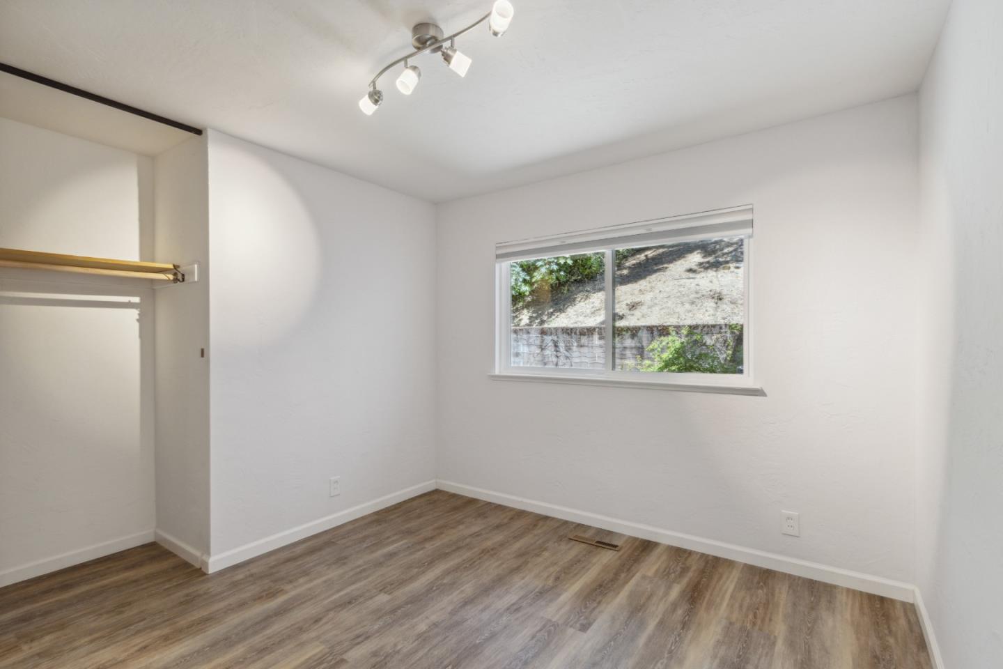 24895 Skyland Road Los Gatos, CA 95033 - Photo 38 of 113 an empty room with wooden floor closet and windows