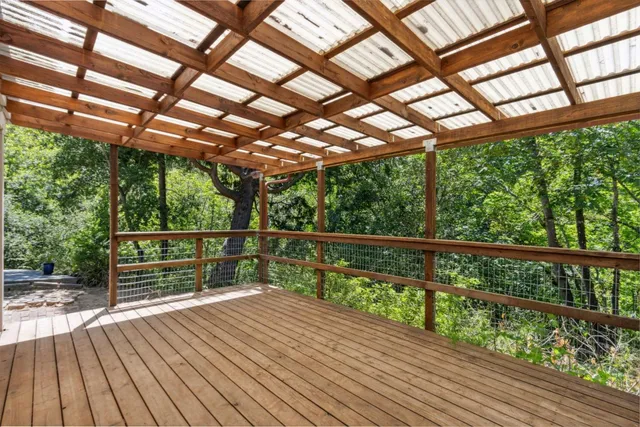 a view of a patio with table and chairs under an umbrella