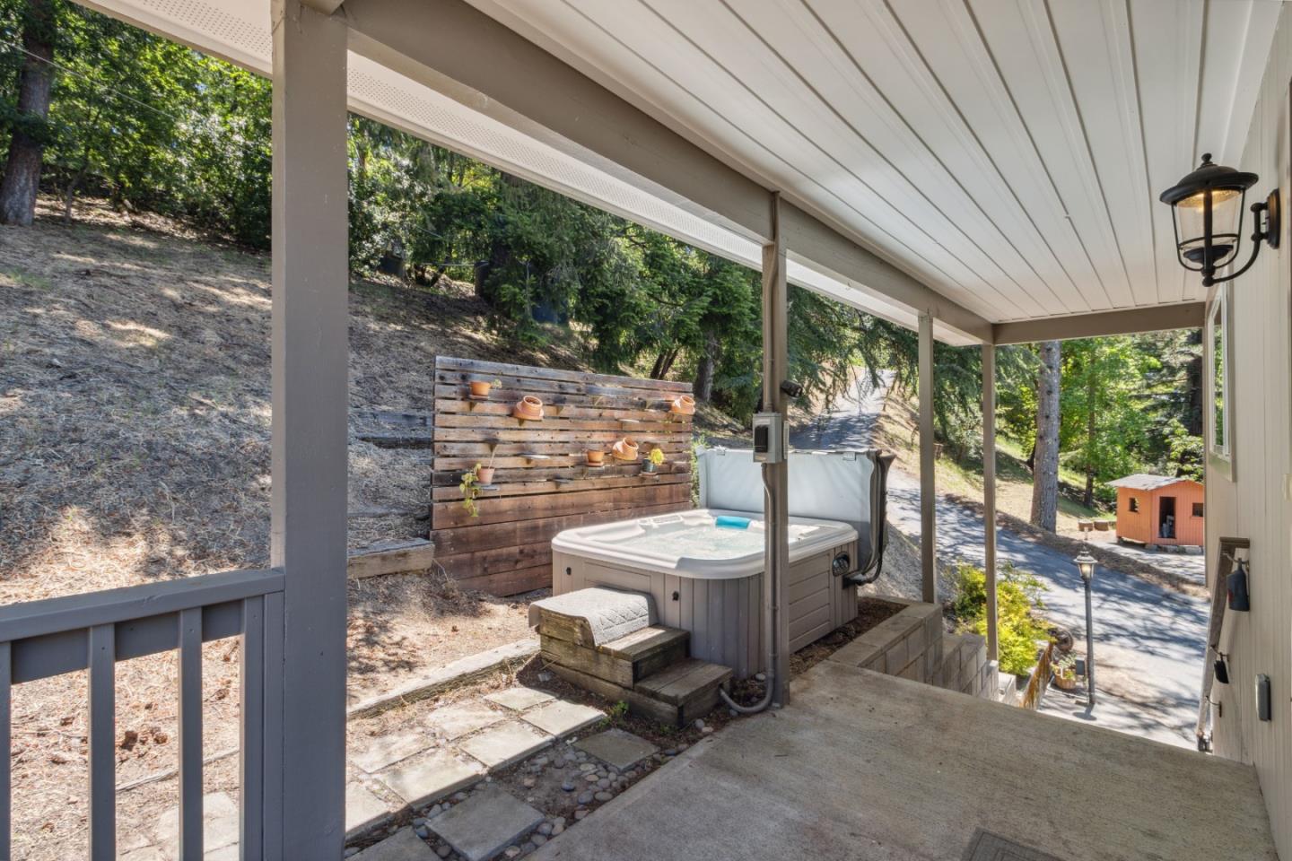 24895 Skyland Road Los Gatos, CA 95033 - Photo 55 of 113 a view of a patio with table and chairs potted plants with wooden floor and fence