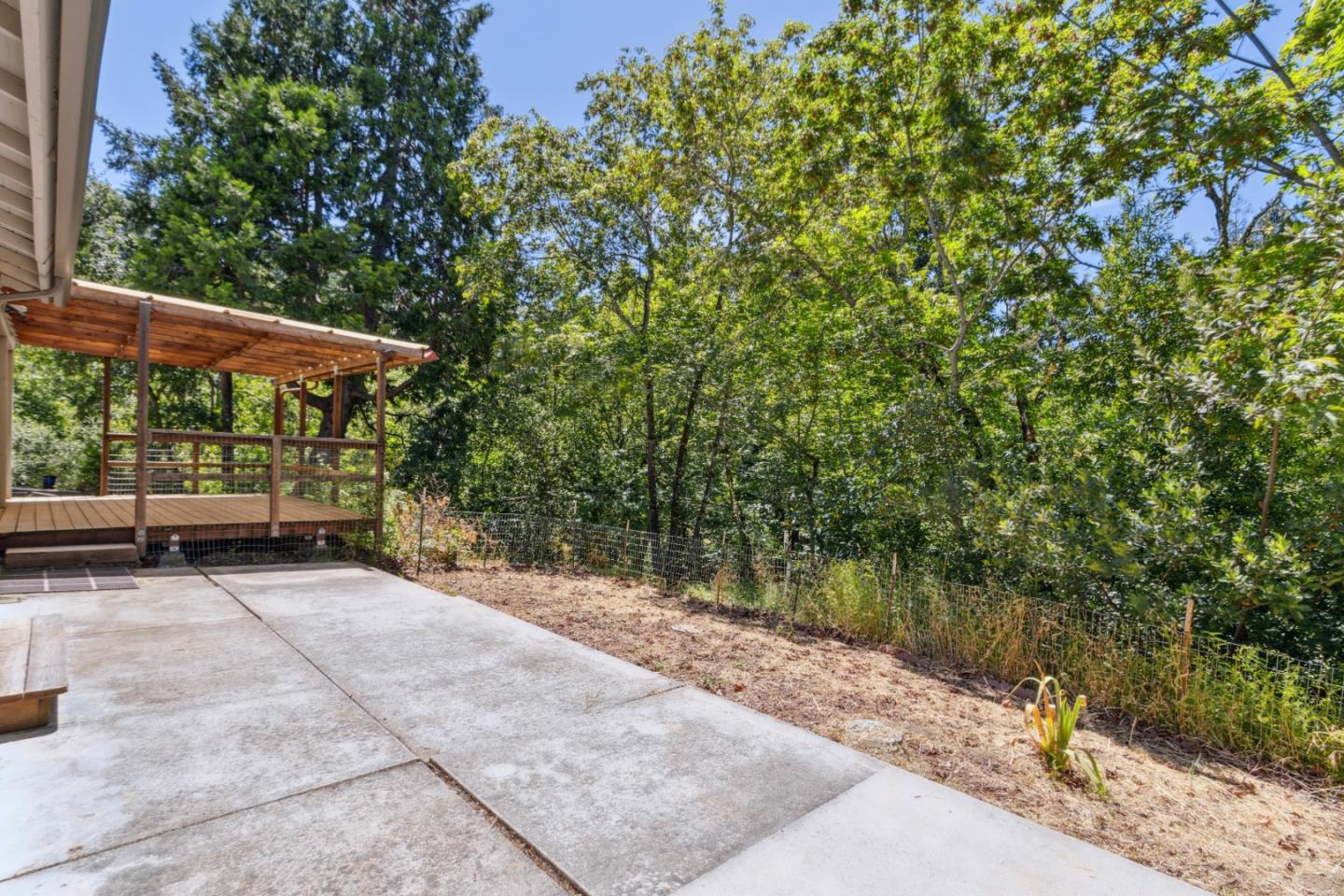 24895 Skyland Road Los Gatos, CA 95033 - Photo 66 of 113 a view of a patio with table and chairs under an umbrella