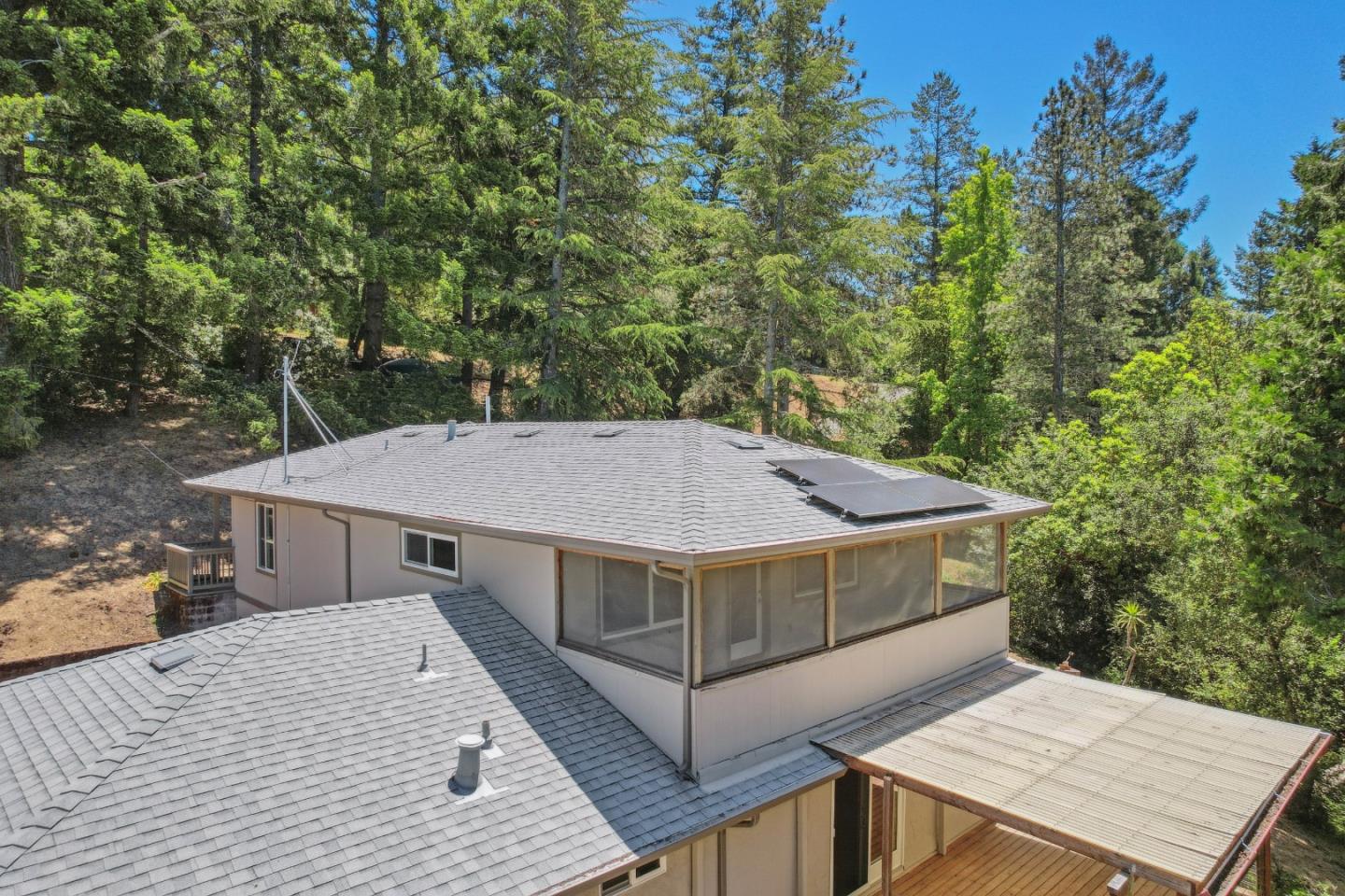 24895 Skyland Road Los Gatos, CA 95033 - Photo 74 of 113 a view of a roof deck with table and chairs a barbeque with wooden floor and fence