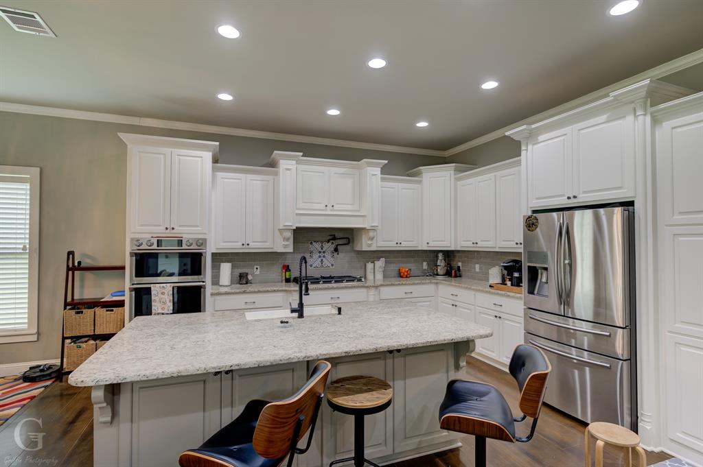 7453 Shirley Francis Road Shreveport, LA 71129 - Photo 11 of 29 a kitchen with stainless steel appliances granite countertop a sink refrigerator and cabinets