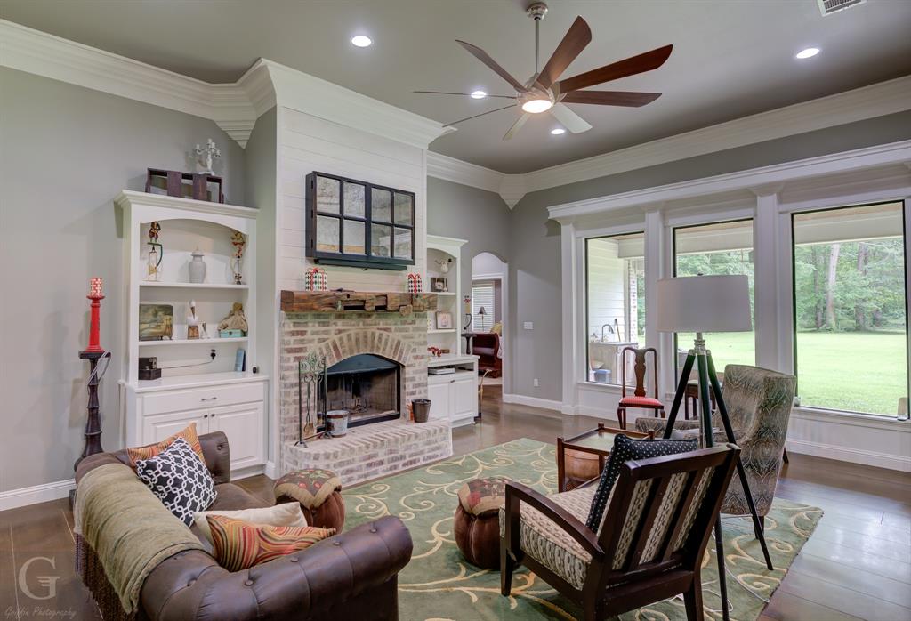 7453 Shirley Francis Road Shreveport, LA 71129 - Photo 5 of 29 a living room with furniture two windows and a fireplace