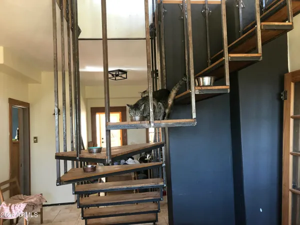 a view of a workspace with furniture and a window