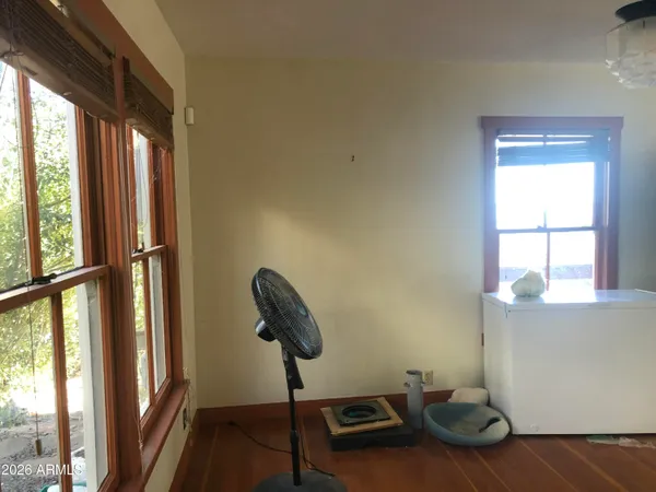 a view of backyard with wooden fence