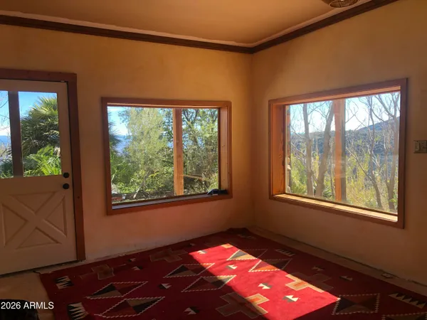 a very nice looking living room with a large window and wooden floor