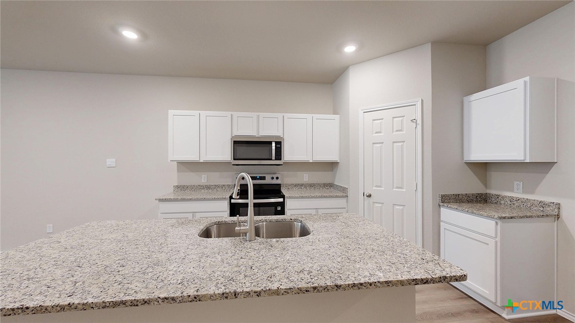 1110 Stone Vly Road Temple, TX 76502 - Photo 15 of 21 a kitchen with stainless steel appliances granite countertop a sink stove and cabinets