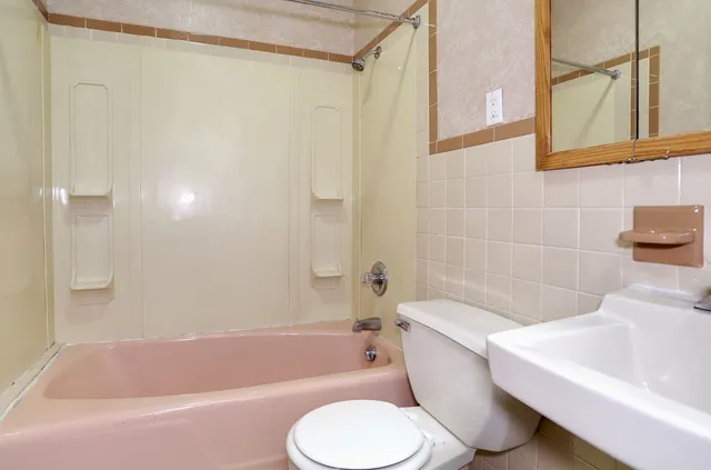 a bathroom with a toilet bathtub and shower