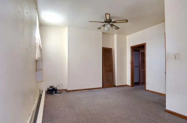 a view of a room with a ceiling fan