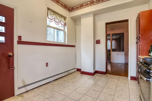 a view of an entryway with wooden floor and cabinet