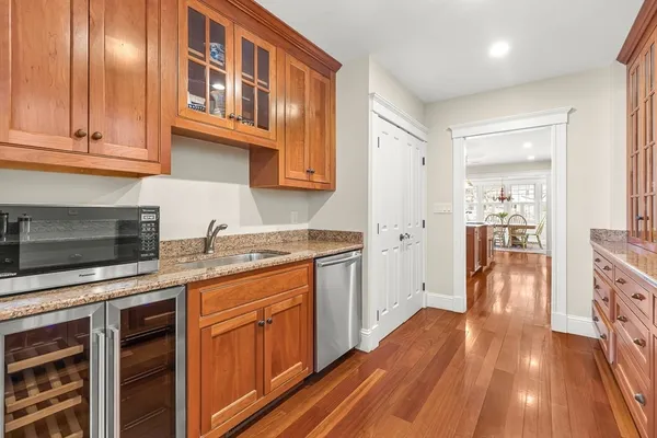 a kitchen with stainless steel appliances granite countertop hardwood floor sink stove and cabinets