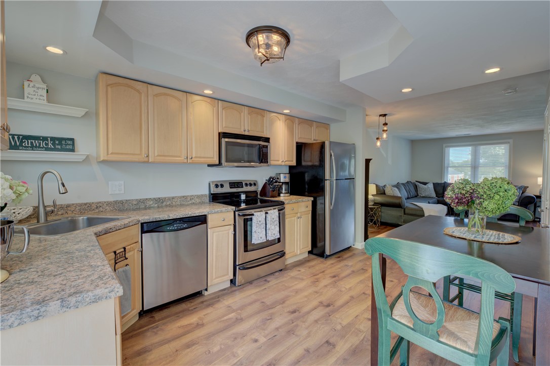3399 Post Road, Unit 9 Warwick, RI 02886 - Photo 12 of 26 Updated kitchen with wood flooring throughout living room and kitchen