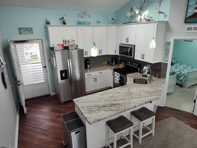 a kitchen with granite countertop a stove and a sink