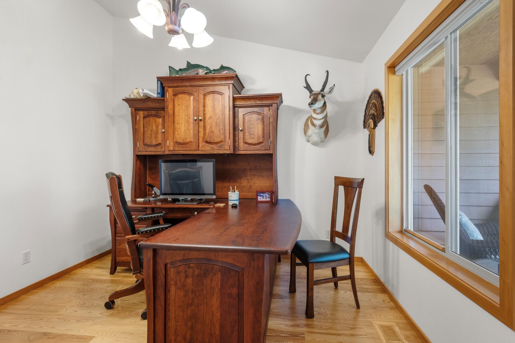 64585 Joe Neil Road Bend, OR 97701 - Photo 22 of 35 a view of a dining room with furniture window and wooden floor