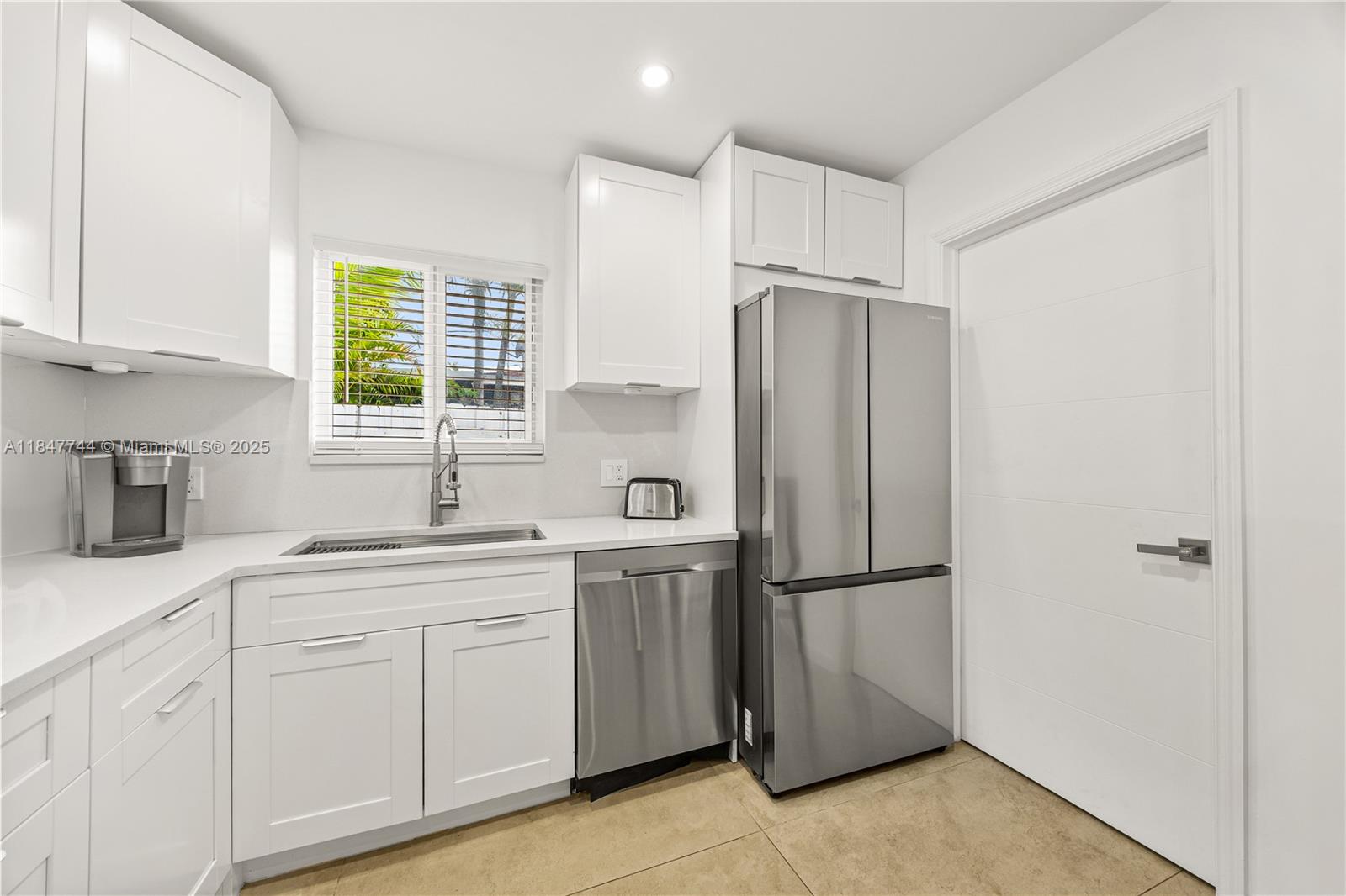 3246 Pierce Street Hollywood, FL 33021 - Photo 11 of 41 a kitchen with stainless steel appliances granite countertop a refrigerator sink and cabinets