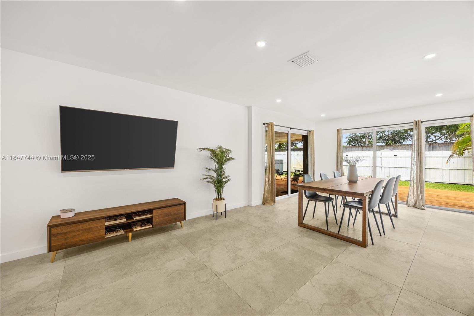 3246 Pierce Street Hollywood, FL 33021 - Photo 12 of 41 a view of a livingroom with furniture and a flat screen tv
