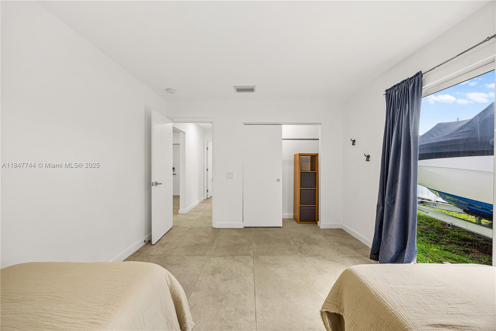 3246 Pierce Street Hollywood, FL 33021 - Photo 21 of 41 a bedroom with a bed and a painting on the wall