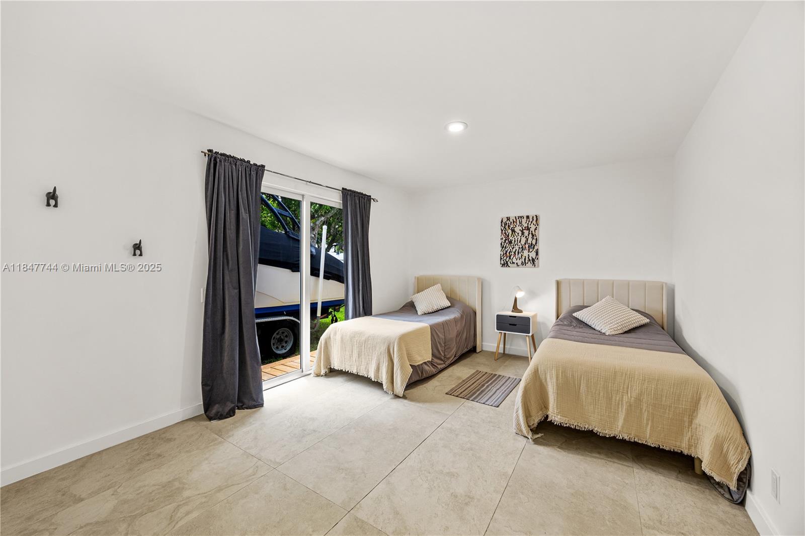 3246 Pierce Street Hollywood, FL 33021 - Photo 22 of 41 a spacious bedroom with a bed and a couch