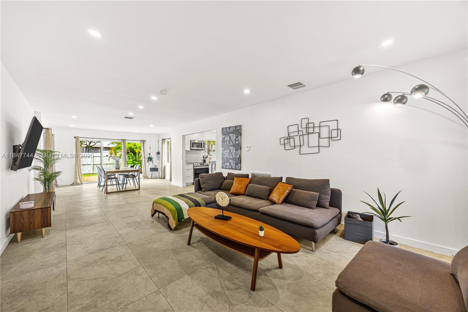 3246 Pierce Street Hollywood, FL 33021 - Photo 5 of 41 a living room with furniture and a flat screen tv