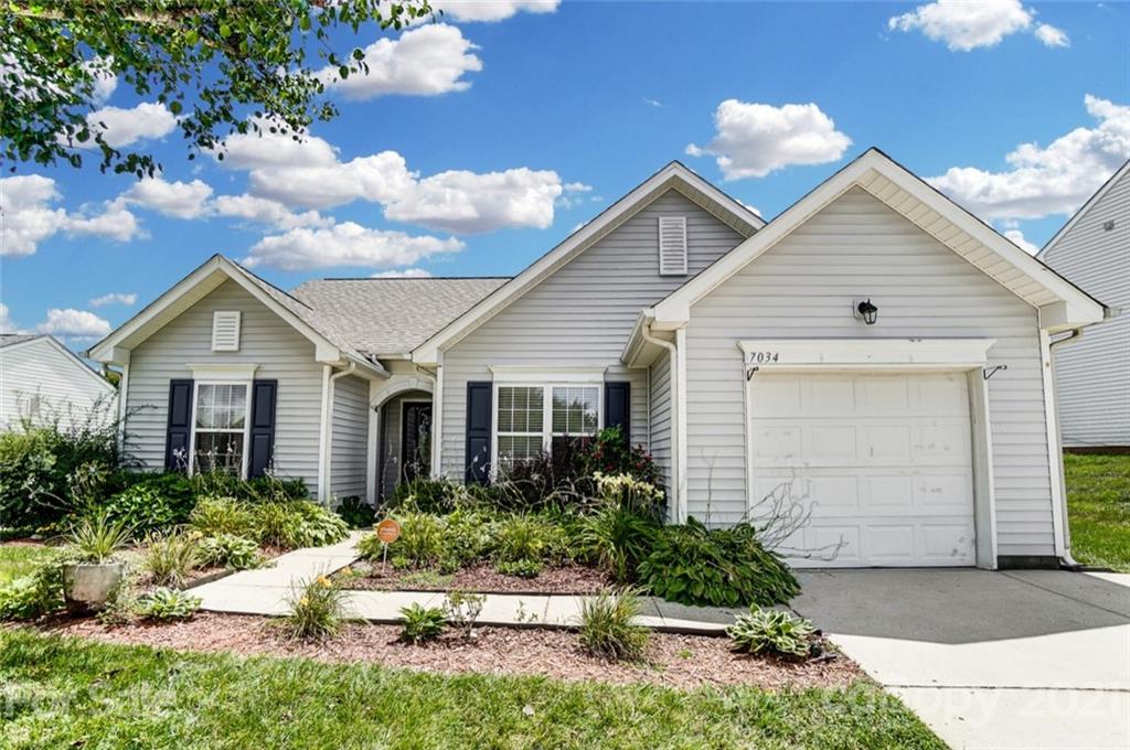 7034 Blithe Low Place Charlotte, NC 28273 - Photo 2 of 31 a view of front of house with a yard