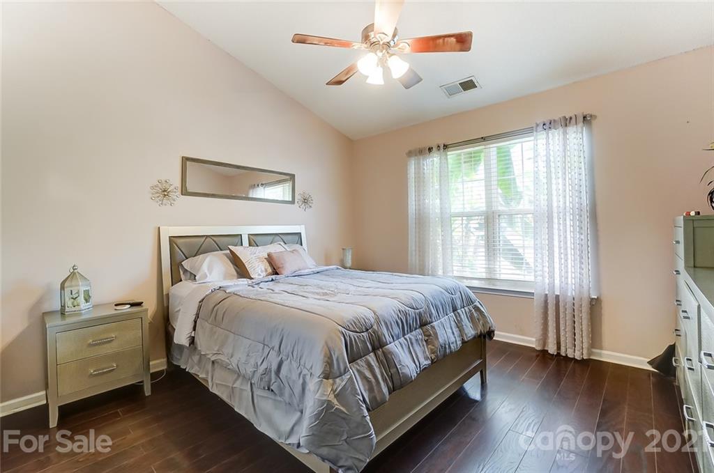 7034 Blithe Low Place Charlotte, NC 28273 - Photo 15 of 31 a bedroom with a bed and a chandelier