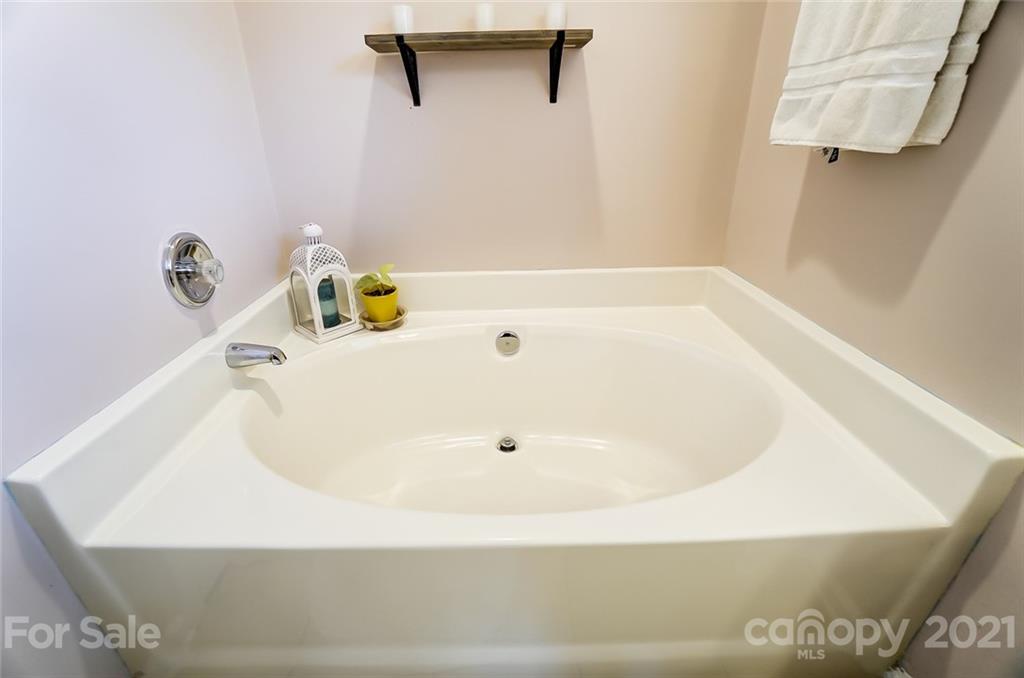 7034 Blithe Low Place Charlotte, NC 28273 - Photo 18 of 31 a bathroom with a white bath tub