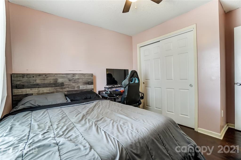 7034 Blithe Low Place Charlotte, NC 28273 - Photo 21 of 31 a bedroom with a bed and a television