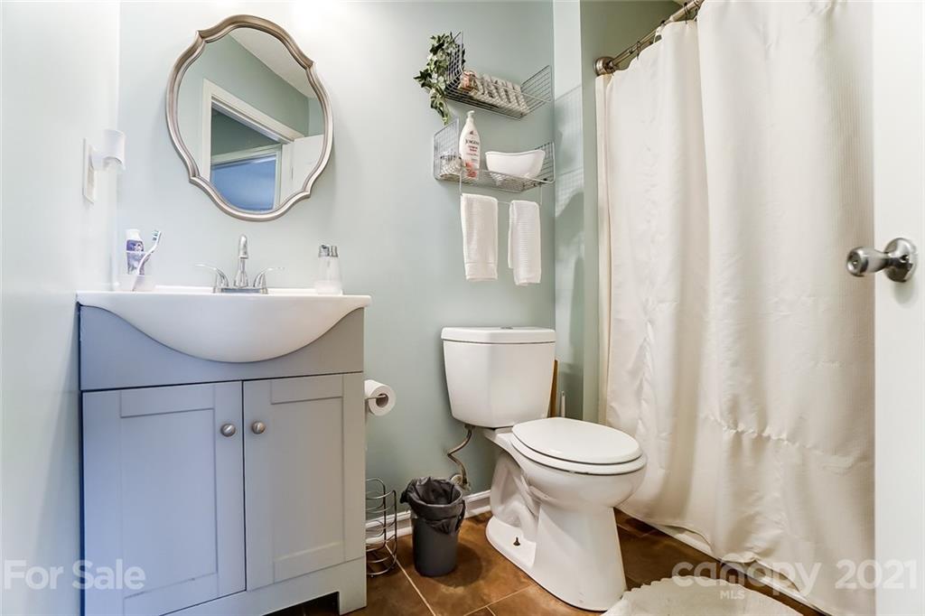 7034 Blithe Low Place Charlotte, NC 28273 - Photo 22 of 31 a bathroom with a sink toilet and a mirror