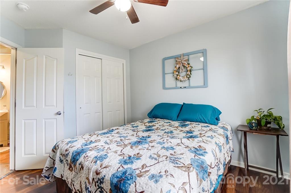 7034 Blithe Low Place Charlotte, NC 28273 - Photo 24 of 31 a bedroom with a bed and a chandelier