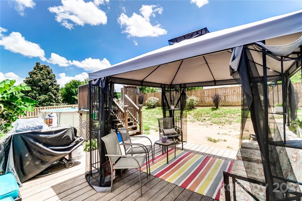 7034 Blithe Low Place Charlotte, NC 28273 - Photo 28 of 31 a view of balcony with wooden floor and outdoor seating