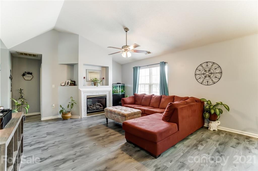 7034 Blithe Low Place Charlotte, NC 28273 - Photo 7 of 31 a living room with furniture and a fireplace