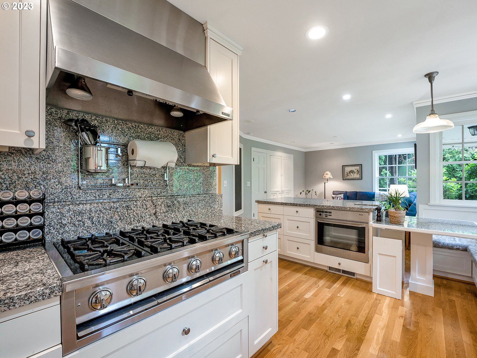 2828 Southwest Sunset Boulevard Portland, OR 97239 - Photo 11 of 32 a kitchen with a stove and a wooden floor