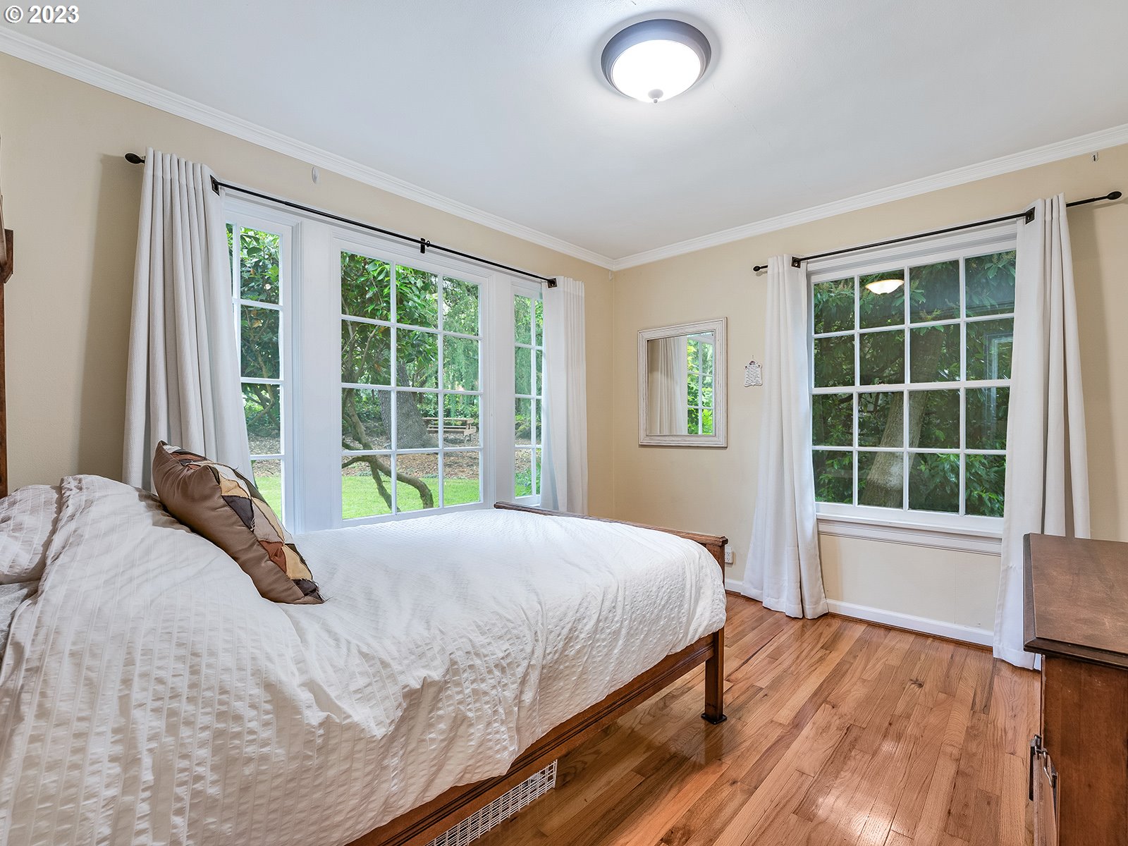 2828 Southwest Sunset Boulevard Portland, OR 97239 - Photo 14 of 32 a large bed sitting in a bedroom next to a window