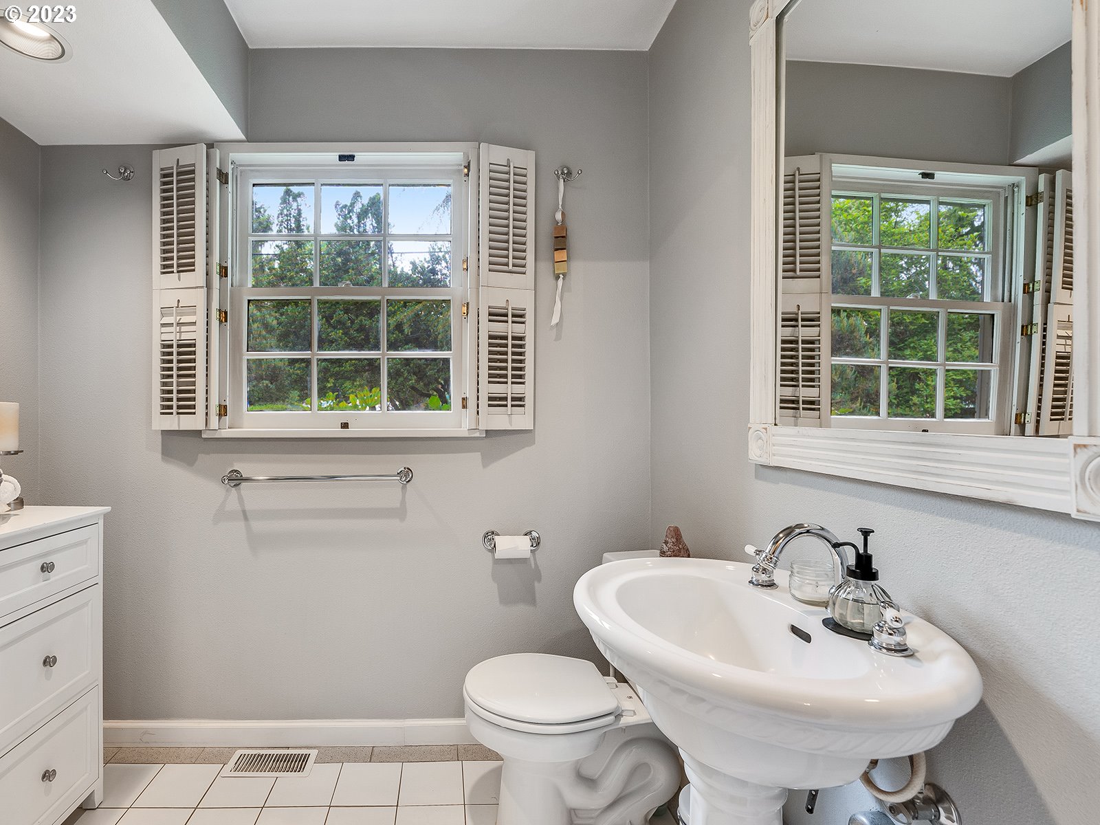 2828 Southwest Sunset Boulevard Portland, OR 97239 - Photo 15 of 32 a bathroom with a sink a toilet and a window