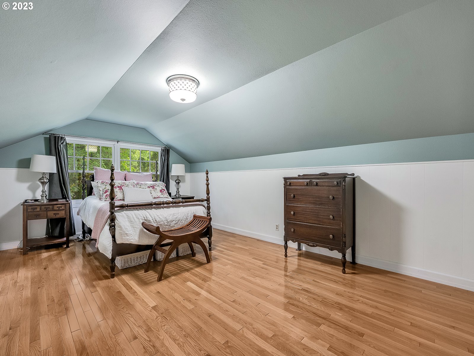 2828 Southwest Sunset Boulevard Portland, OR 97239 - Photo 17 of 32 a bedroom with furniture and a wooden floor
