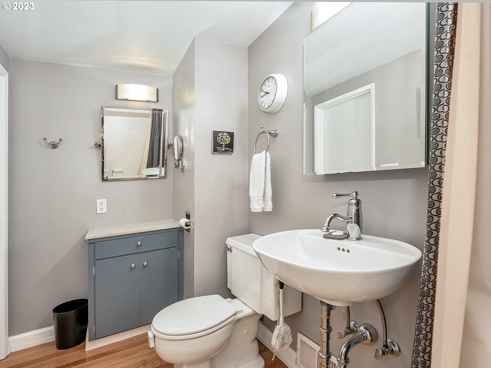2828 Southwest Sunset Boulevard Portland, OR 97239 - Photo 19 of 32 a bathroom with a toilet a sink and mirror