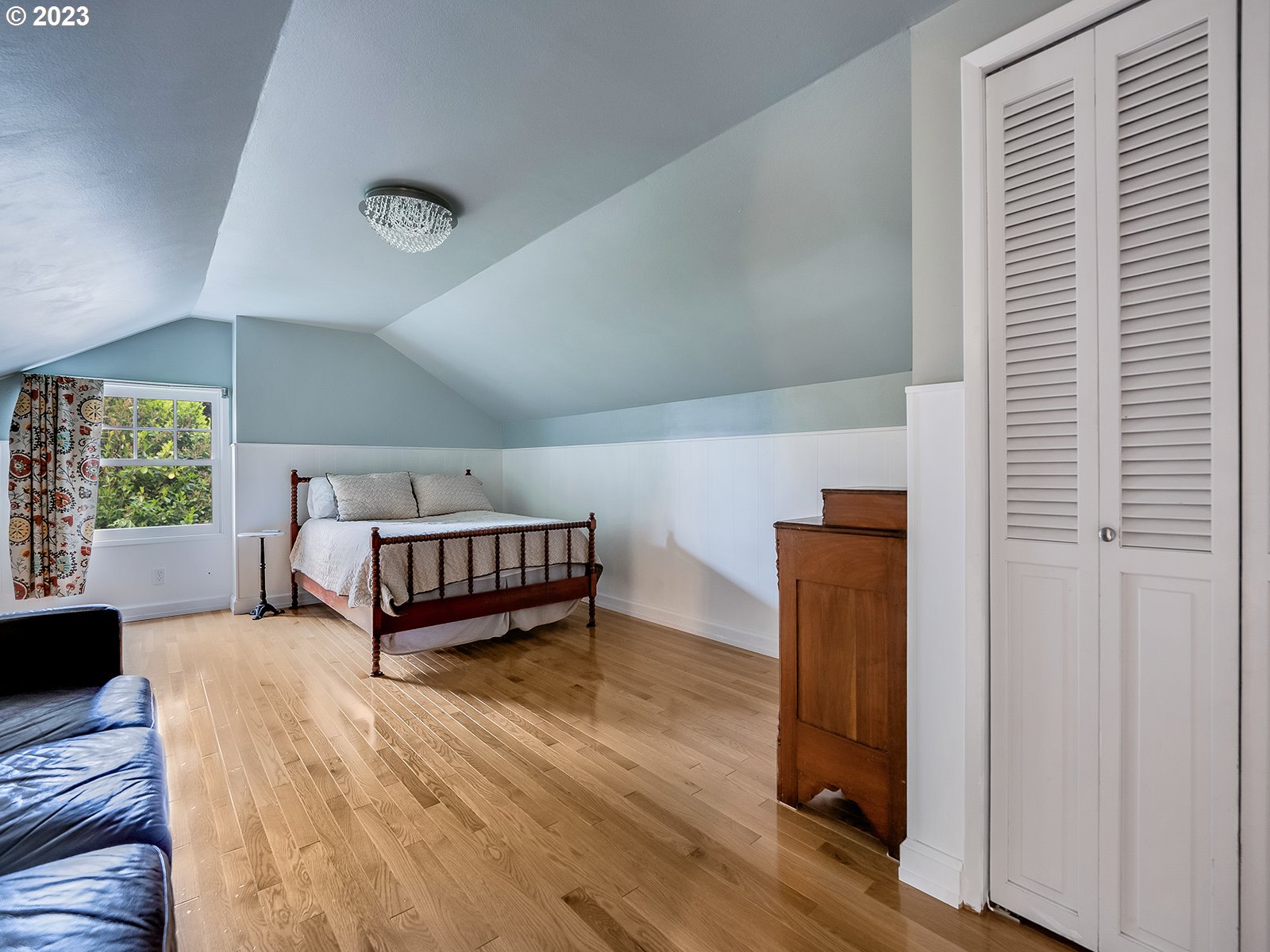 2828 Southwest Sunset Boulevard Portland, OR 97239 - Photo 21 of 32 a bedroom with furniture and a window