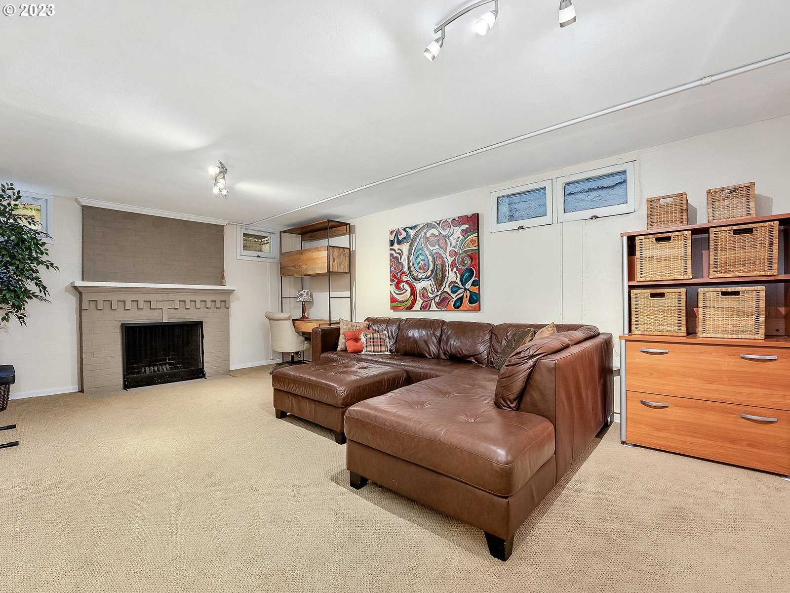 2828 Southwest Sunset Boulevard Portland, OR 97239 - Photo 22 of 32 a living room with furniture and a fireplace