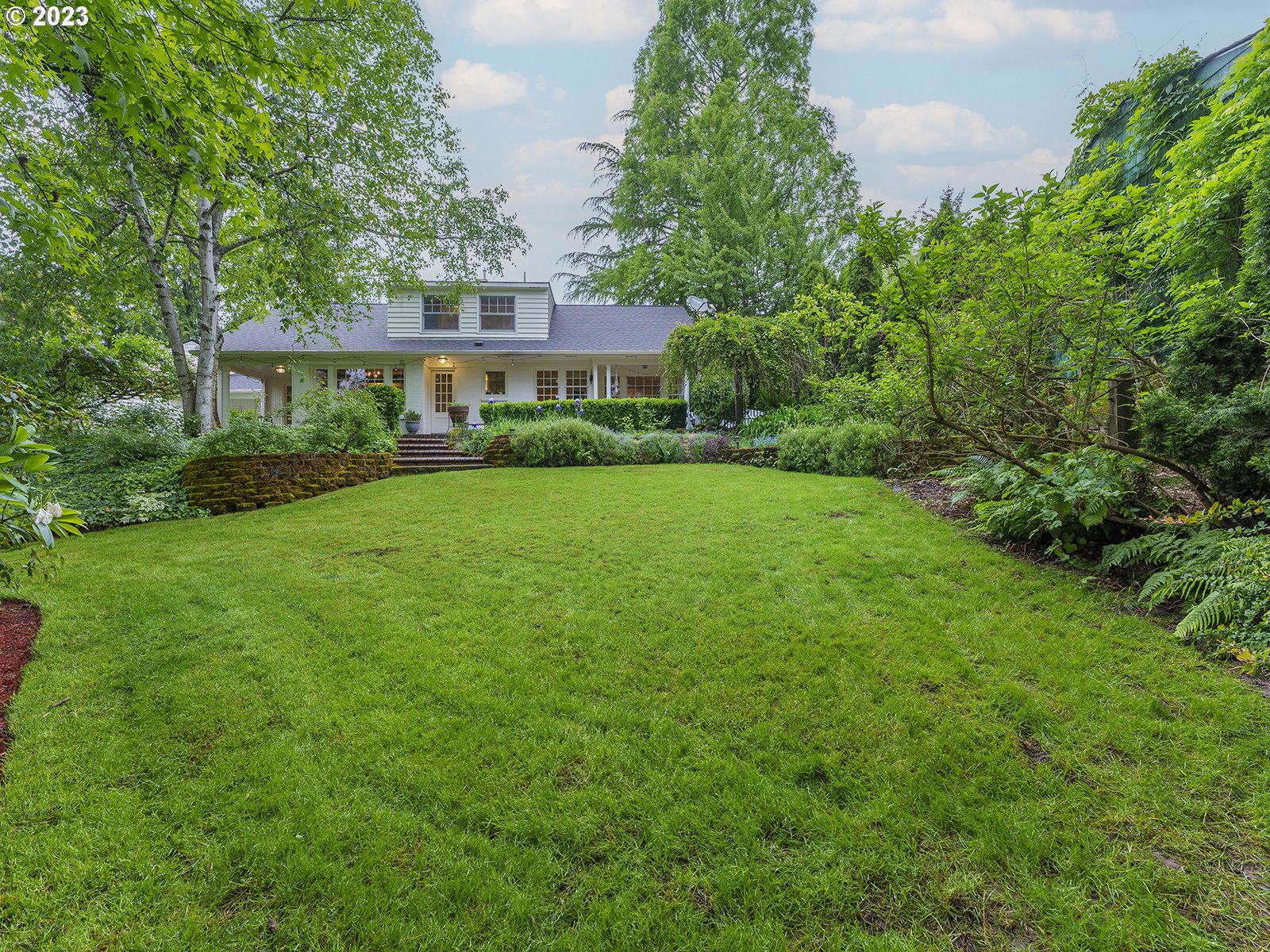 2828 Southwest Sunset Boulevard Portland, OR 97239 - Photo 28 of 32 a view of a big yard with plants and large trees