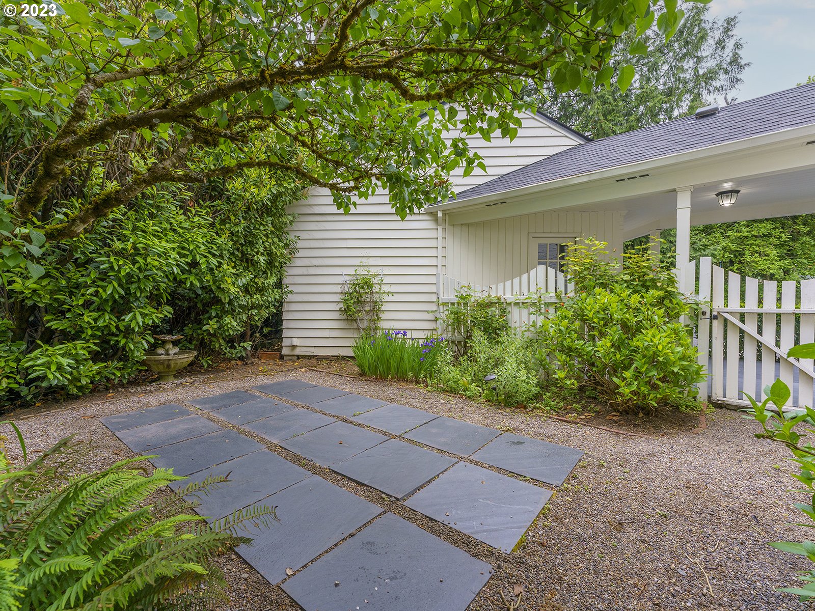 2828 Southwest Sunset Boulevard Portland, OR 97239 - Photo 31 of 32 a front view of a house with garden