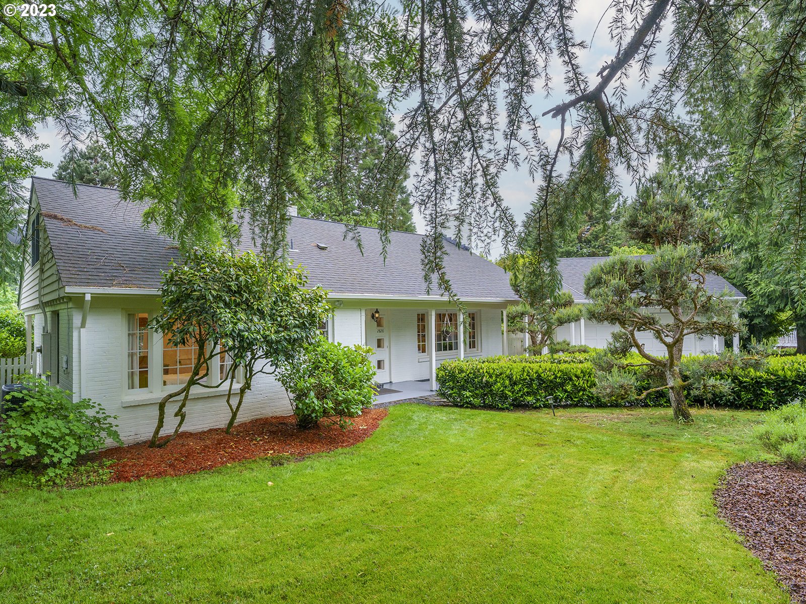 2828 Southwest Sunset Boulevard Portland, OR 97239 - Photo 32 of 32 a front view of a house with a garden