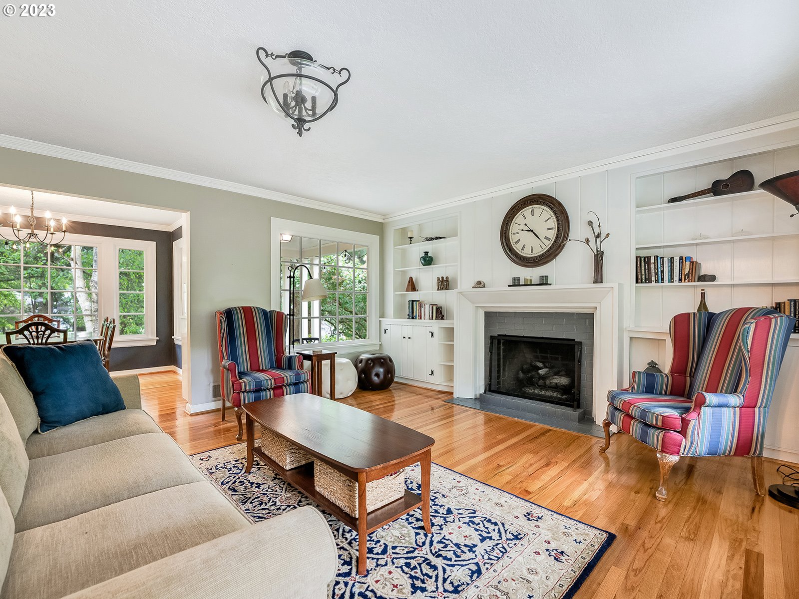 2828 Southwest Sunset Boulevard Portland, OR 97239 - Photo 5 of 32 a living room with furniture a rug and a fireplace