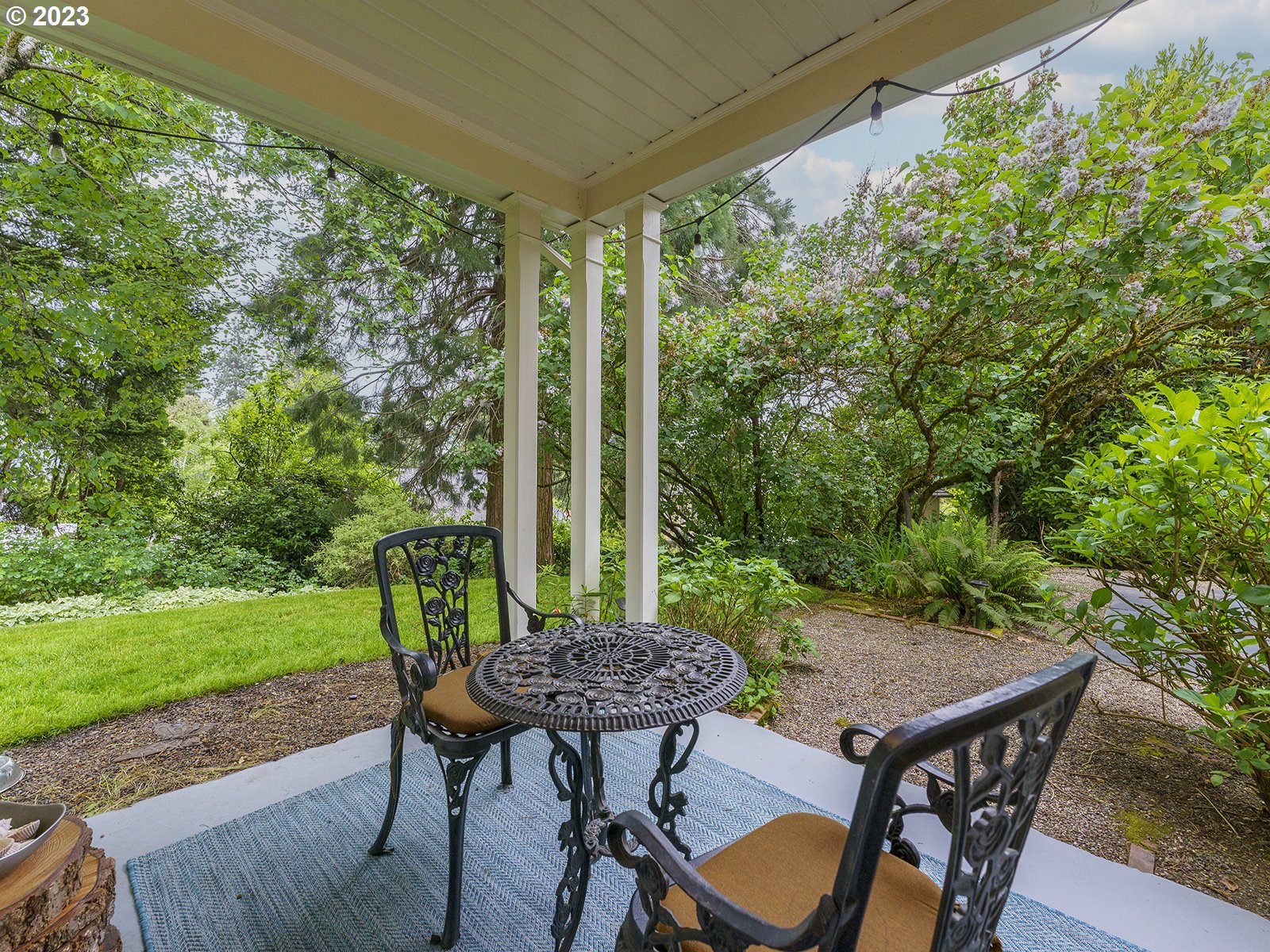 2828 Southwest Sunset Boulevard Portland, OR 97239 - Photo 8 of 32 a view of a patio with a table chairs and a backyard