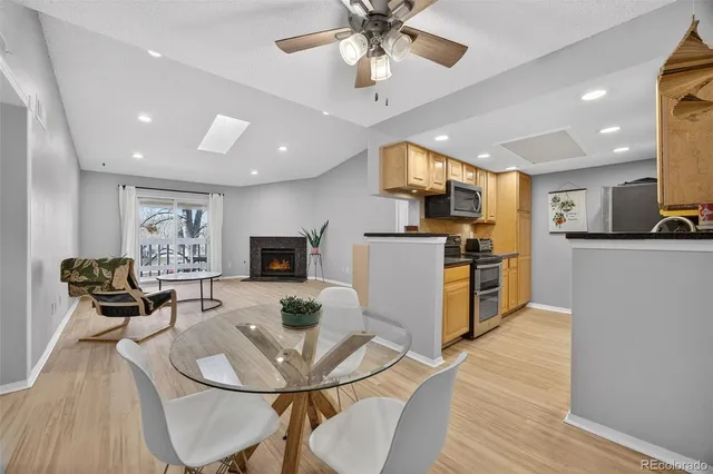 a living room with stainless steel appliances kitchen island granite countertop furniture a dining table and chairs